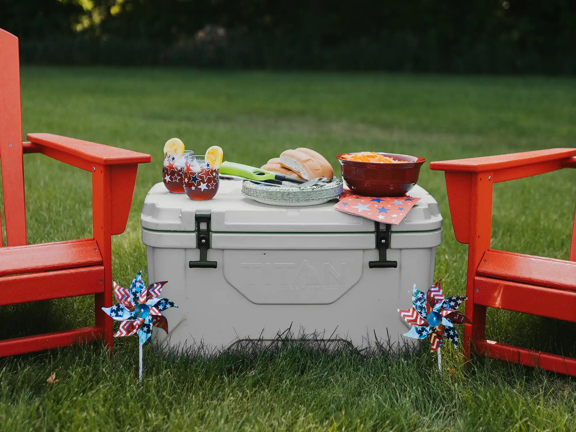 Food and drinks on top of a Titan 55Q Hard Cooler outside during a Memorial Day party