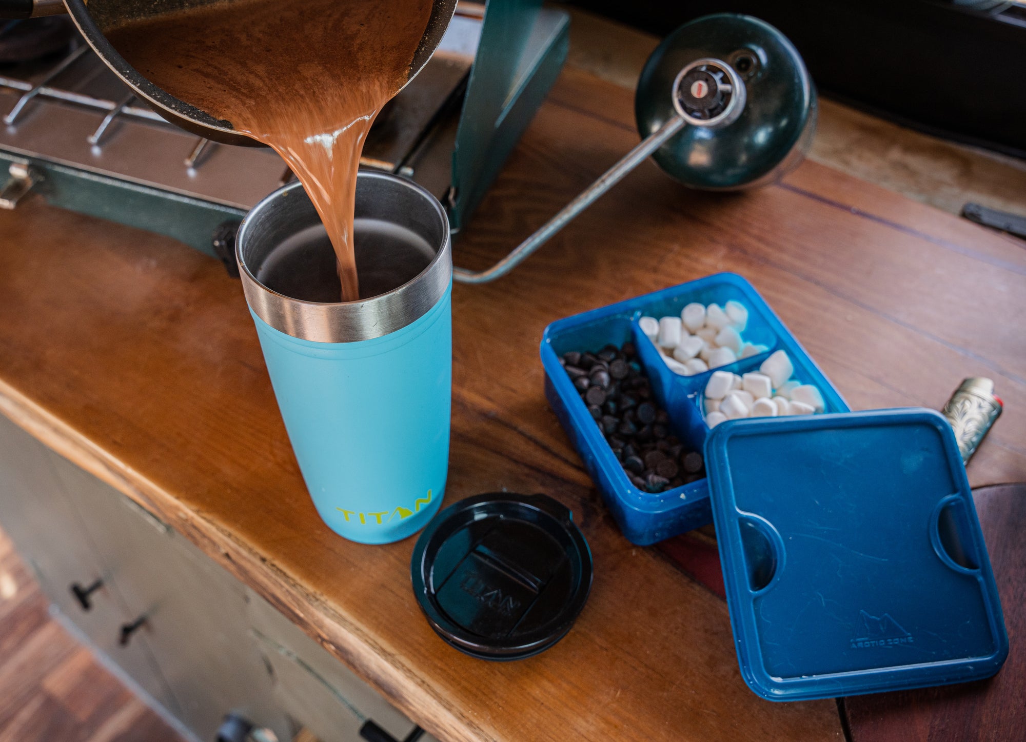 Saucepan of creamy homemade hot chocolate being poured into a Titan 20 Oz. Stainless Steel Tumbler