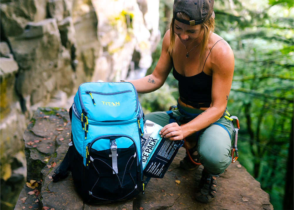 Lady pulling out Ice Walls from a Titan Backpack Cooler